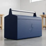 A navy blue toolbox with a lightning bolt symbol on a concrete workshop floor.