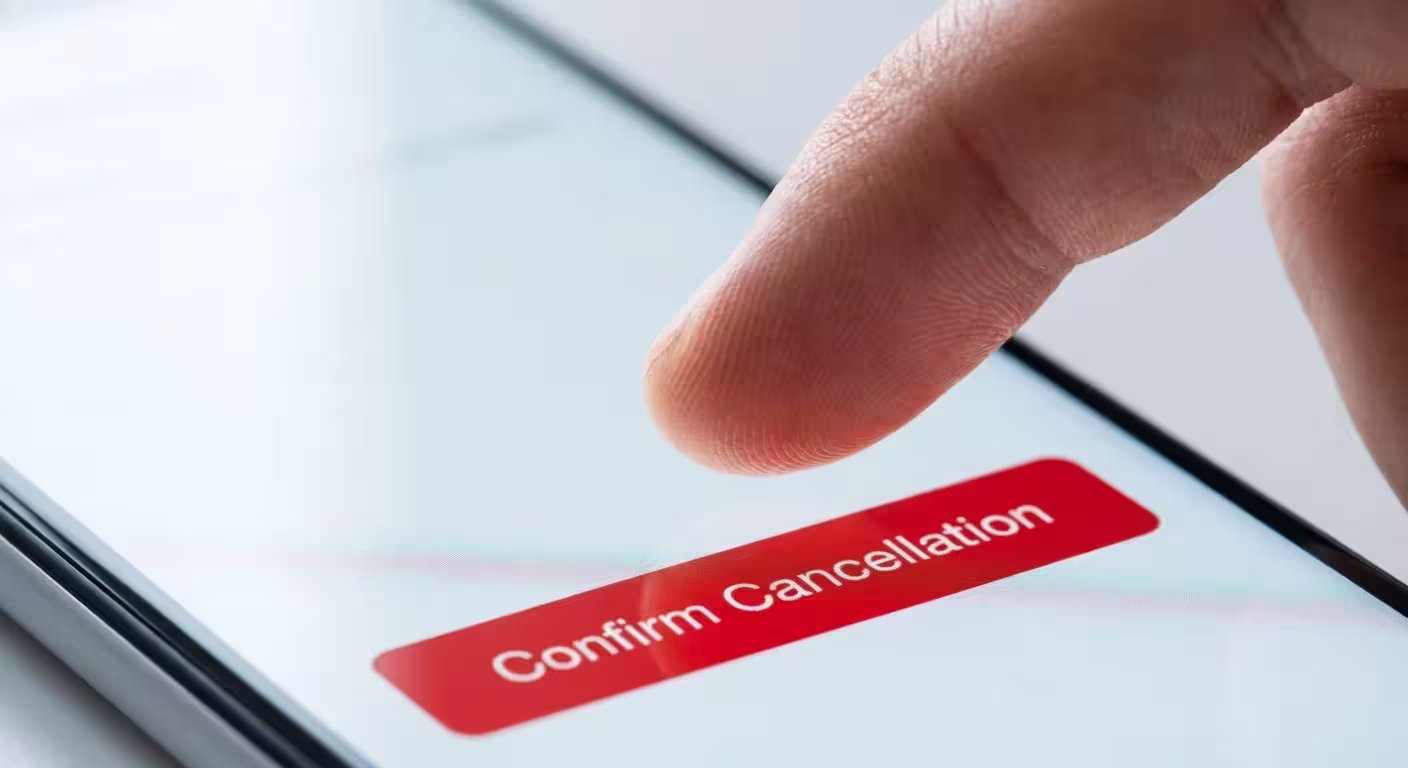 Finger tapping a red confirm cancellation button on a white mobile phone screen
