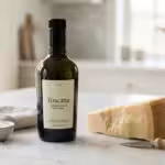 Bottle of Toscana olive oil and Parmesan cheese on a bright marble kitchen counter